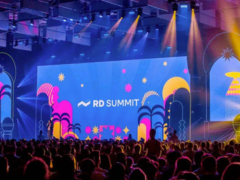 "RD Summit 2023 main stage with colorful decorations and audience"